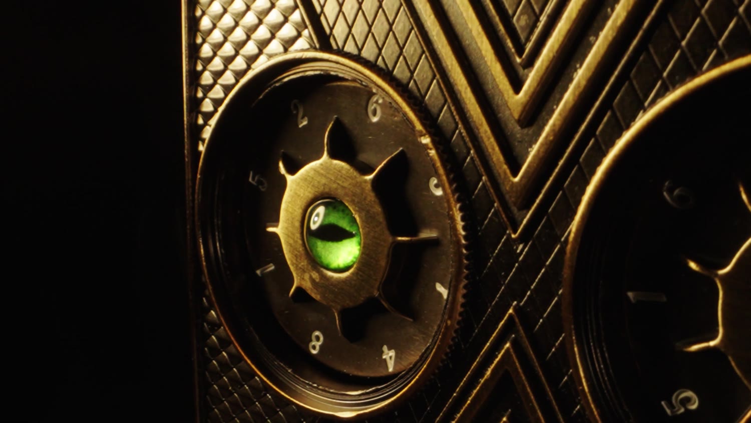 Close-up of a dial with the green cat-eye dragon stone at its center
